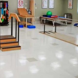 A physical therapy room equipped with exercise equipment for rehabilitation and fitness training.