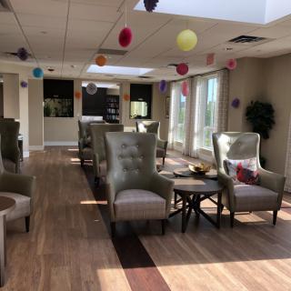 A well-lit lounge area with comfortable seating and colorful decorations.
