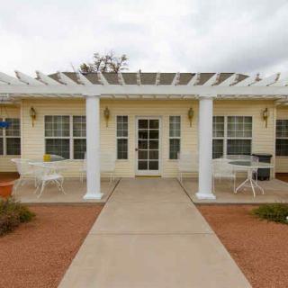 A single-story building with a front patio and white columns.