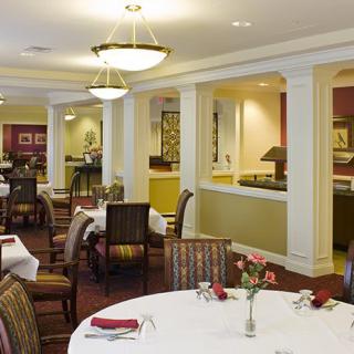 An elegant dining room interior with neatly arranged tables and chairs.