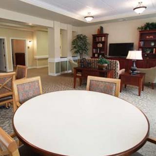 A cozy living room with a seating area, table, and television.