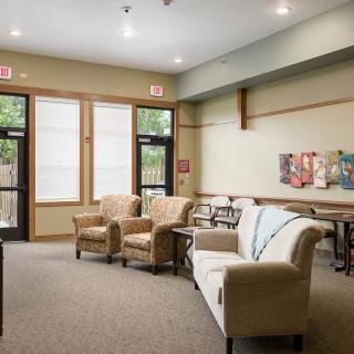 A cozy living room with comfortable seating and large windows.
