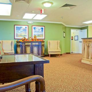 A cozy waiting room with comfortable seating and decorative artwork.