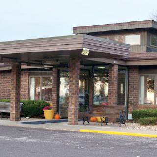 A modern brick building with an inviting entrance and landscaped surroundings.