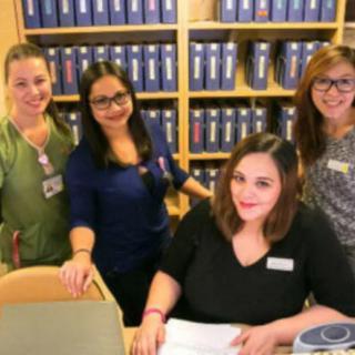 A group of women working together in an office setting.