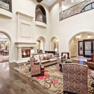 Spacious and luxurious living room with elegant decor and a cozy fireplace.