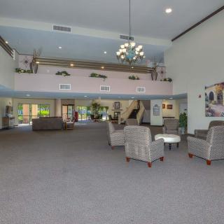 A spacious lobby area with comfortable seating and a chandelier.