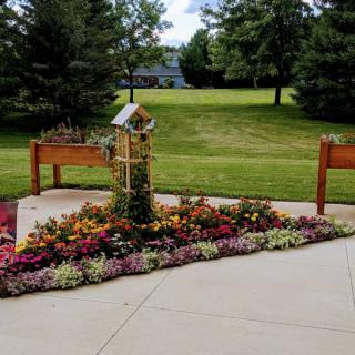 A well-maintained garden with colorful flowers and raised planters in a peaceful outdoor setting.