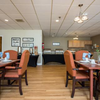 A cozy and modern dining area with neatly arranged tables, chairs, and tasteful decor.