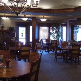 A cozy restaurant dining area with wooden tables and chairs.