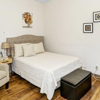 A cozy bedroom with a bed, nightstand, and wall decorations.