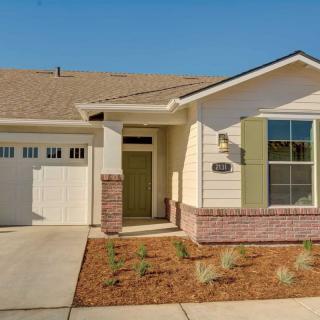 A single-story house with a garage and brick facade.