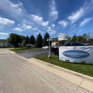 An outdoor view of a healthcare clinic with a parking lot and clear blue skies.