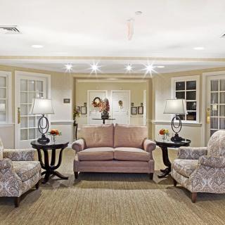 A cozy living room with elegant furniture and warm lighting.