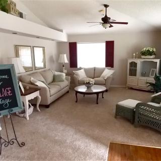 A cozy living room featuring a sofa set, coffee table, and elegant decor.