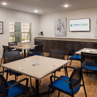 A modern conference room with tables and chairs arranged for a meeting.