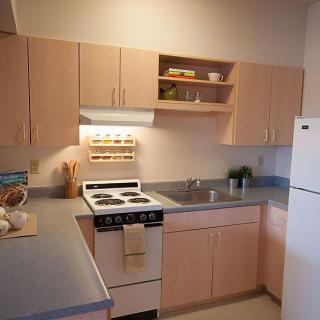 A clean and organized kitchen with modern appliances and wooden cabinets.