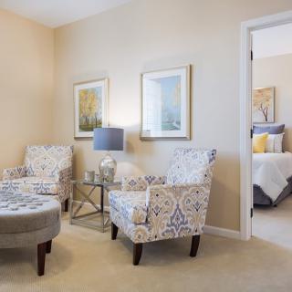 A stylish living room with patterned chairs and elegant decor.