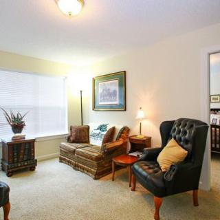 A cozy living room with comfortable seating and warm lighting.