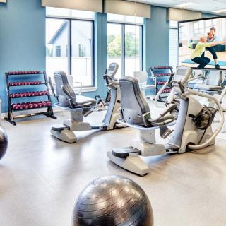 A well-equipped gym with various exercise machines and weights.
