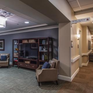 A cozy waiting area with comfortable seating and a bookshelf.