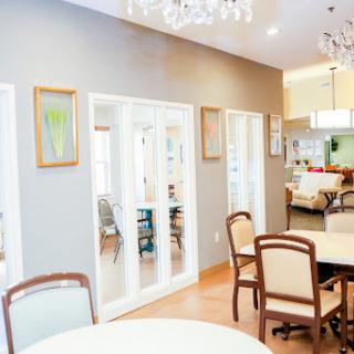 A beautifully designed dining and living area featuring elegant chandeliers and a spacious layout.