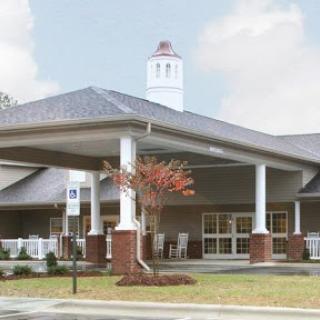 The welcoming facade of a modern residential facility, featuring an inviting entrance and landscaped surroundings.