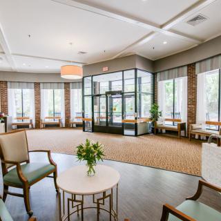 A modern lobby area with comfortable seating and large windows.