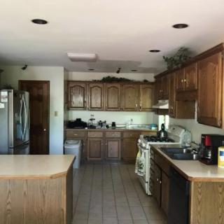 A spacious kitchen featuring wooden cabinetry and modern appliances.