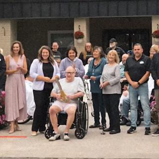 A joyful community gathering celebrating together outdoors.