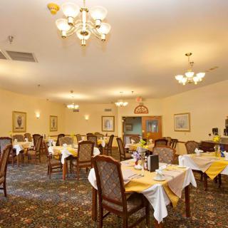 A cozy restaurant dining area with well-arranged tables and elegant chandeliers.