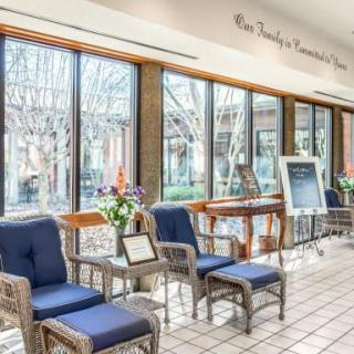 A well-lit lobby with comfortable seating and decorative plants.