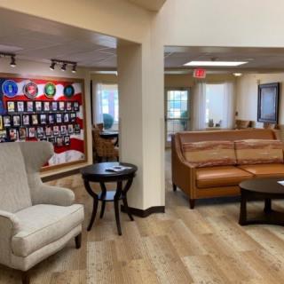 A modern waiting room with comfortable seating and a television for entertainment.