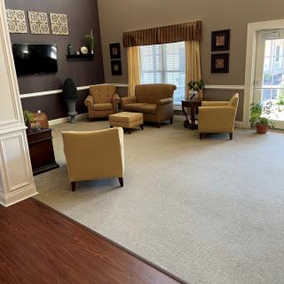 A cozy living room with comfortable seating and a mounted television.