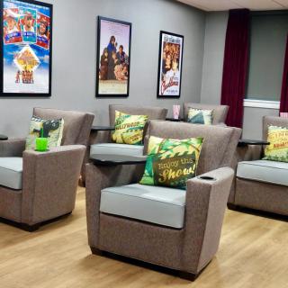 A cozy home theater setup with comfortable seating and movie-themed decor.