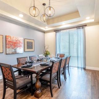 A well-furnished dining room with elegant decor and a stylish chandelier.