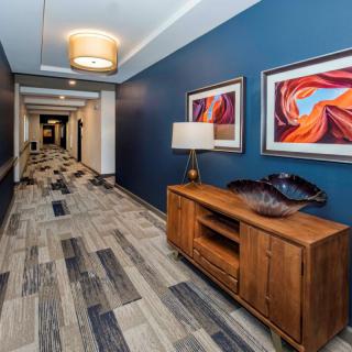 A stylish hallway with colorful artwork and modern decor.