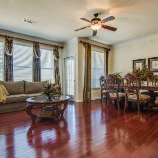 Spacious living and dining area with hardwood floors and a ceiling fan.