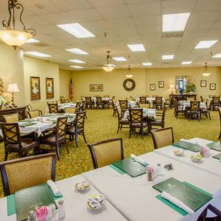 A well-organized conference room with neatly arranged tables and chairs, set up for a meeting.