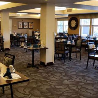 An empty restaurant dining area with neatly arranged tables and chairs.