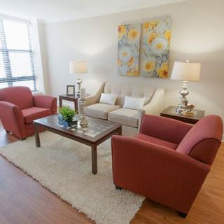 A cozy living room with stylish furnishings and colorful artwork.