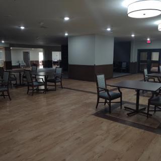A spacious dining area featuring contemporary furniture and ample lighting.