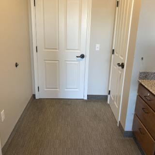 A view of a small room featuring two doors and light-colored walls.