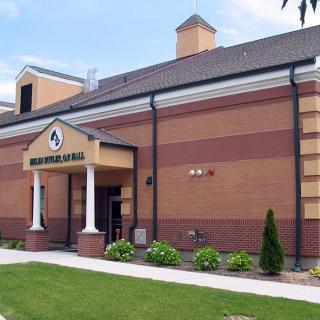 The exterior of a brick bank building with landscaping.