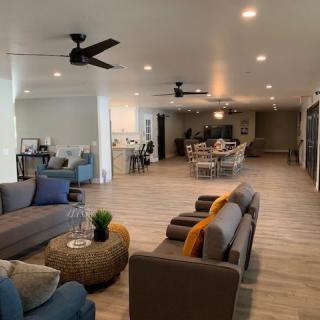 A spacious open-plan living area featuring modern furniture and decor.