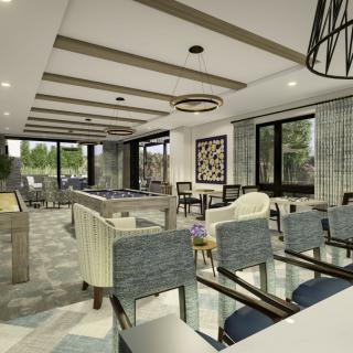 A modern and spacious living room with stylish furniture, ample natural light, and a connected dining area.