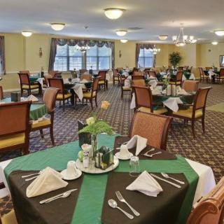 An elegantly set dining area with neatly arranged tables and chairs.