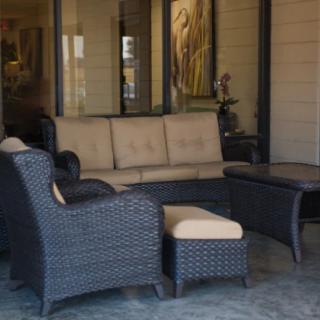 A cozy outdoor patio set with wicker furniture and comfortable cushions.