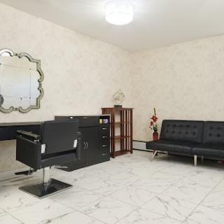 A spacious and modern office interior featuring a sleek desk, comfortable seating, and elegant decor.