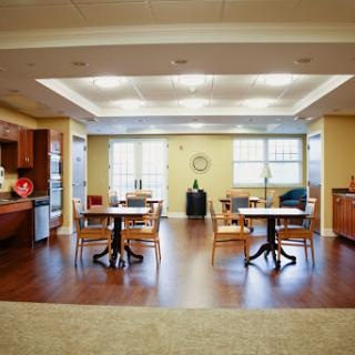 A spacious and well-lit dining area featuring modern furniture, perfect for social gatherings.